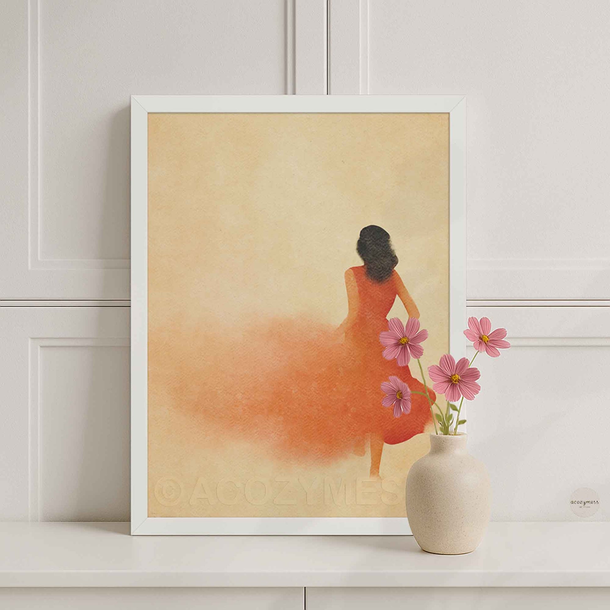 White Framed artwork of a woman in an orange dress.