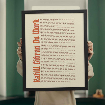 Work motivational poster by Kahlil Gibran in black frame.