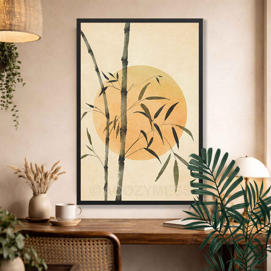 Black Framed artwork with bamboo and sun design on a wall above a wooden desk.
