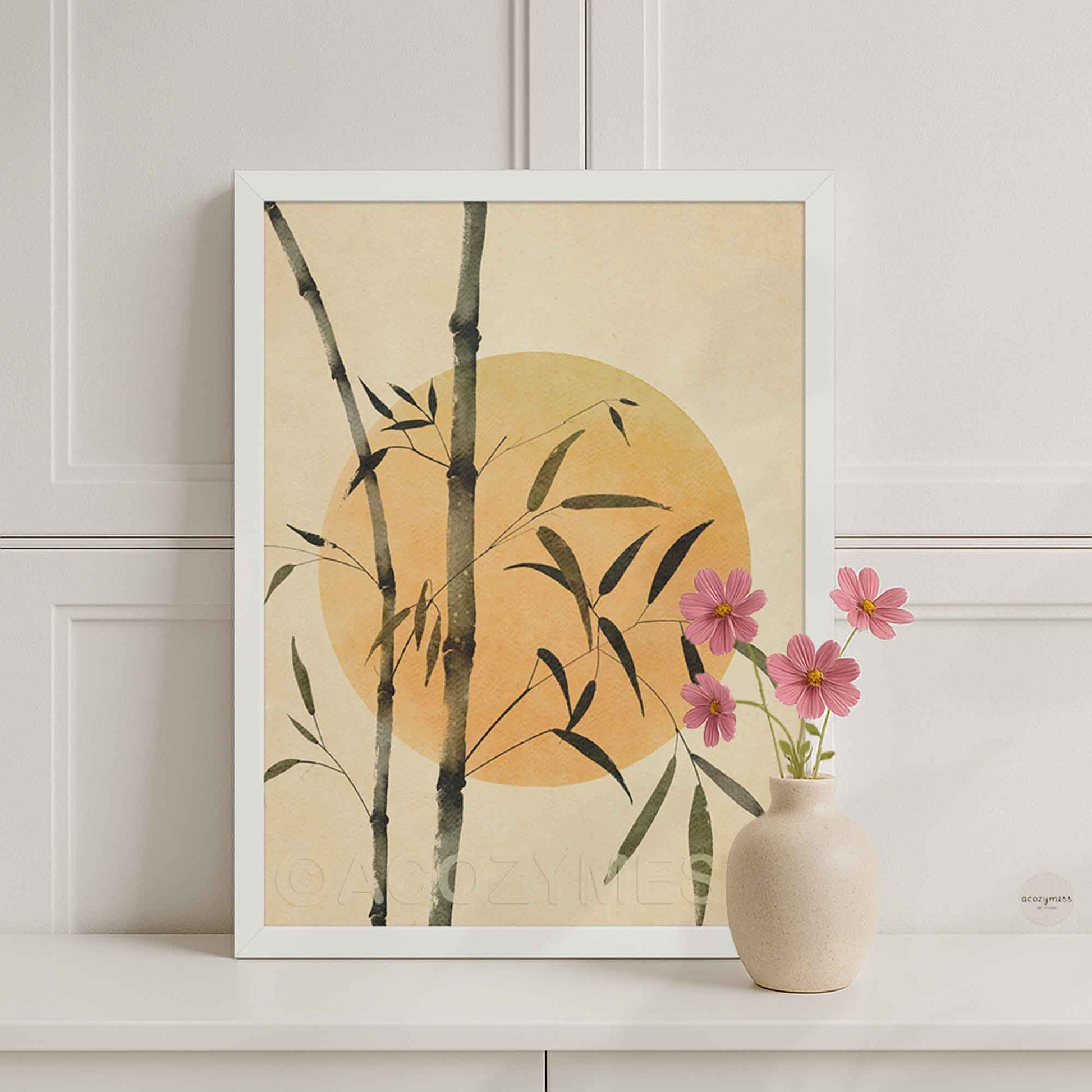 White Framed artwork with bamboo and sun on a beige background.