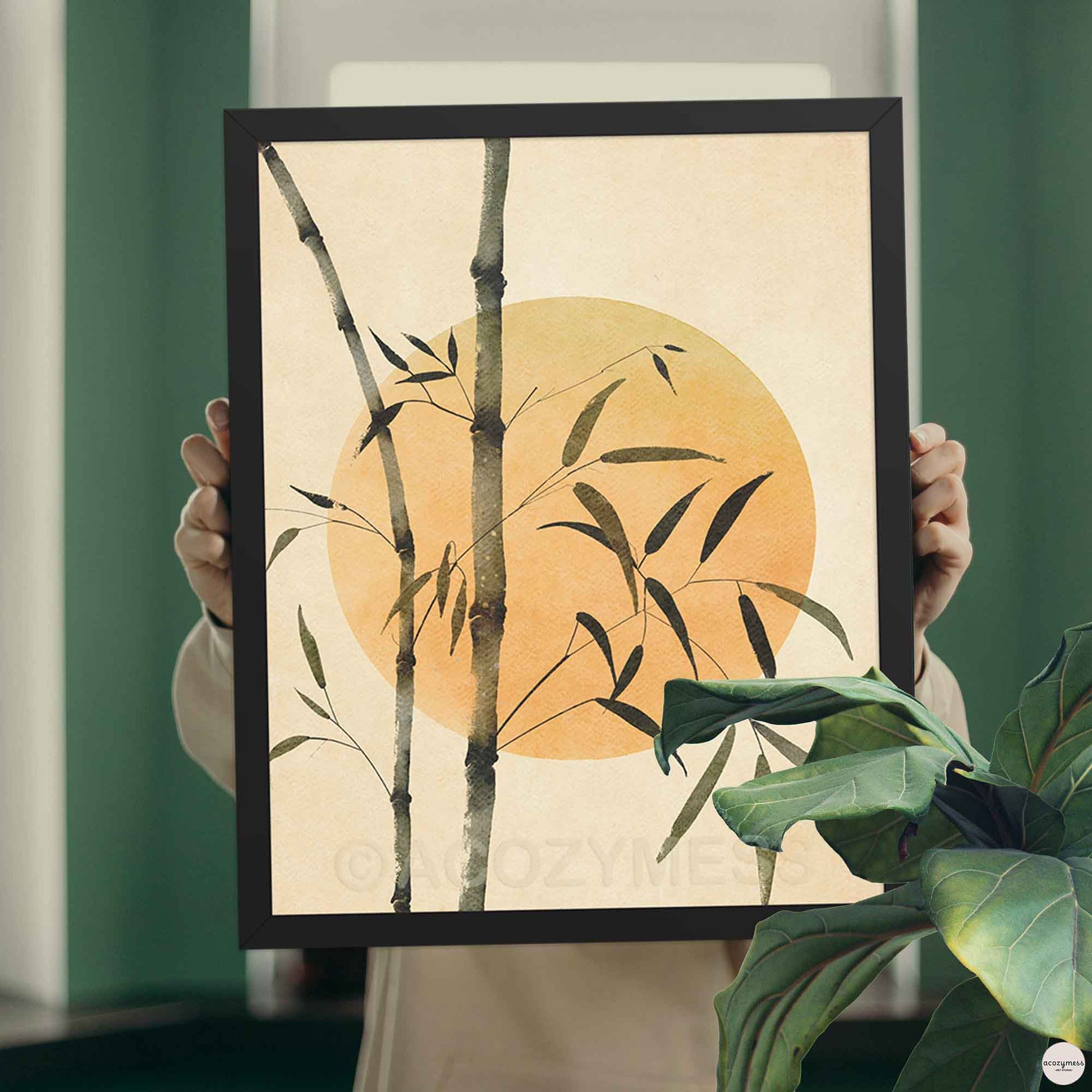 Black Framed artwork with bamboo and a sun artwork.