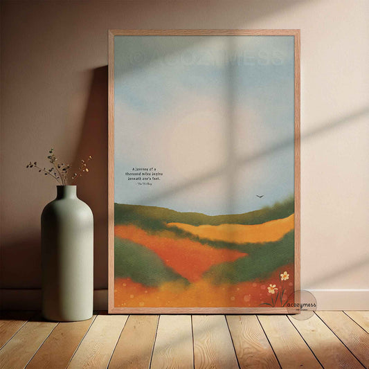Oakwood framed poster featuring the Tao Te Ching quote “A journey of a thousand miles begins beneath one’s feet,” with a colorful landscape illustration.