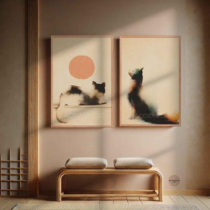 Oak framed cat and peach sun poster hung beside a sitting cat print above a wooden bench