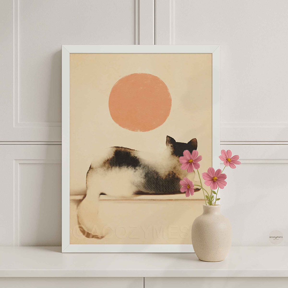 White framed cat looking at the sun poster on a white console with a pink flower vase
