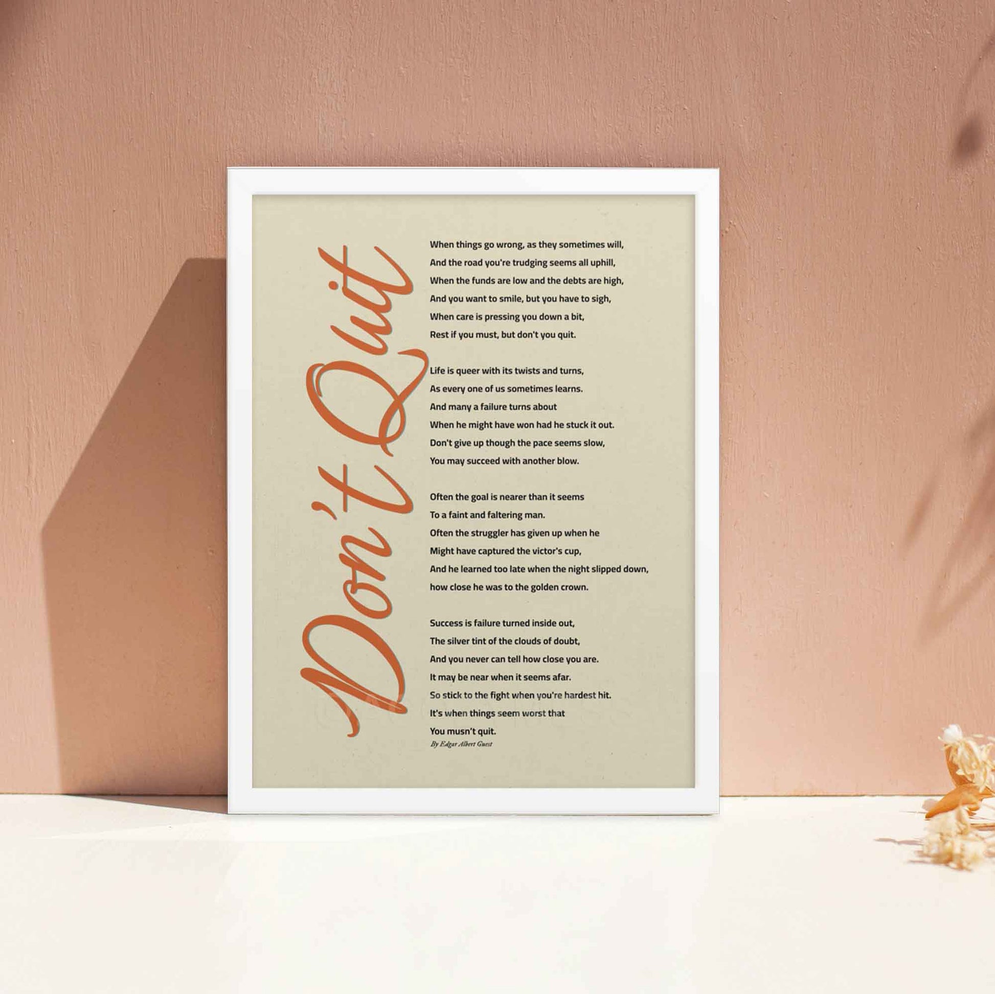 Dont quit poem poster displayed in white frame.