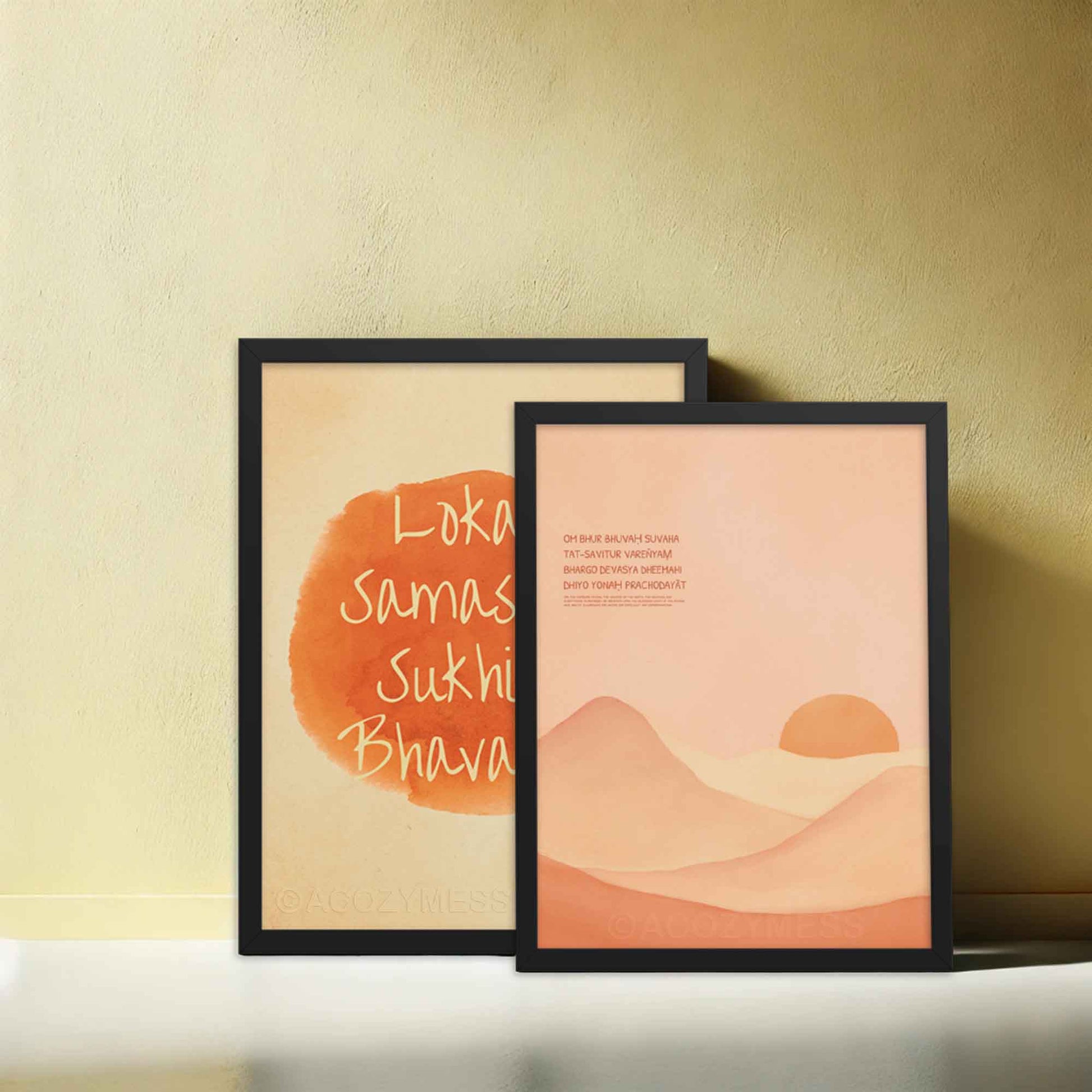 Gayatri Mantra poster featuring calming landscape art in a light color palette, displayed in a black frame, along with Lokah Samastah mantra in black frame