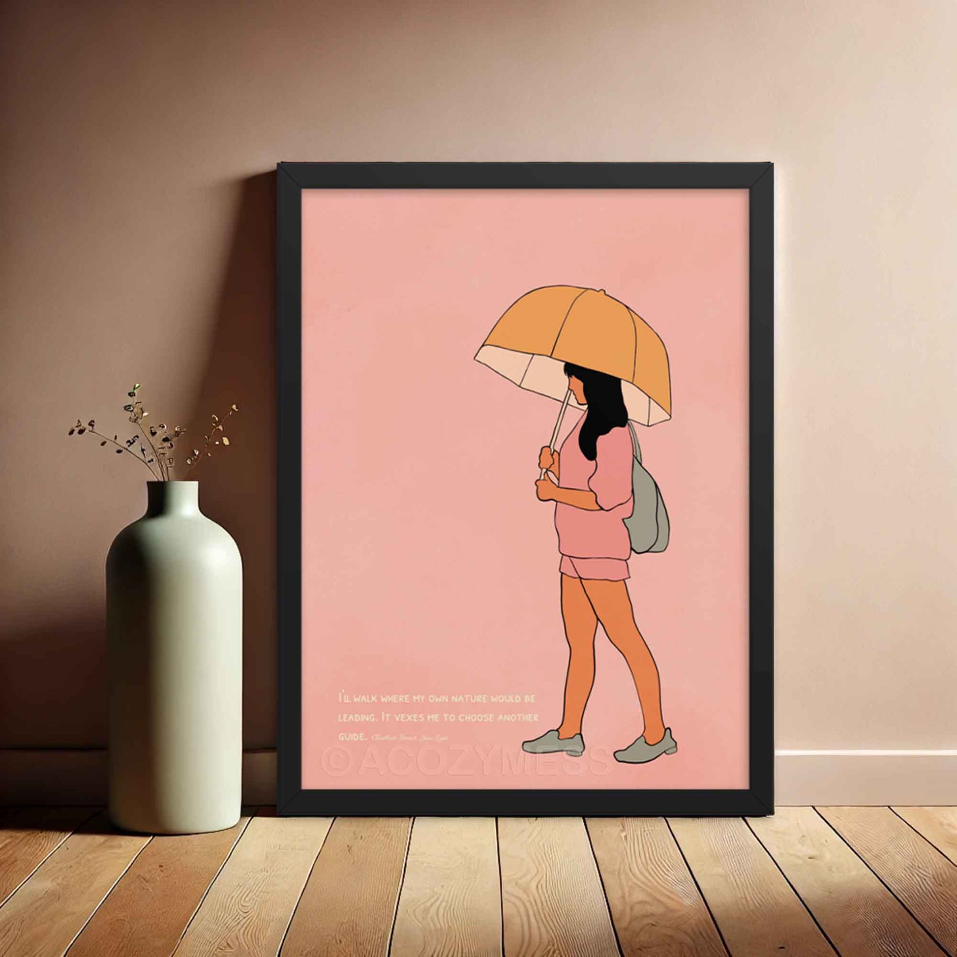 Pink art print with a quote from Charlotte Brontë's Jane Eyre and an illustration of a girl walking with an umbrella, emphasizing independence and self-guidance, in black frame