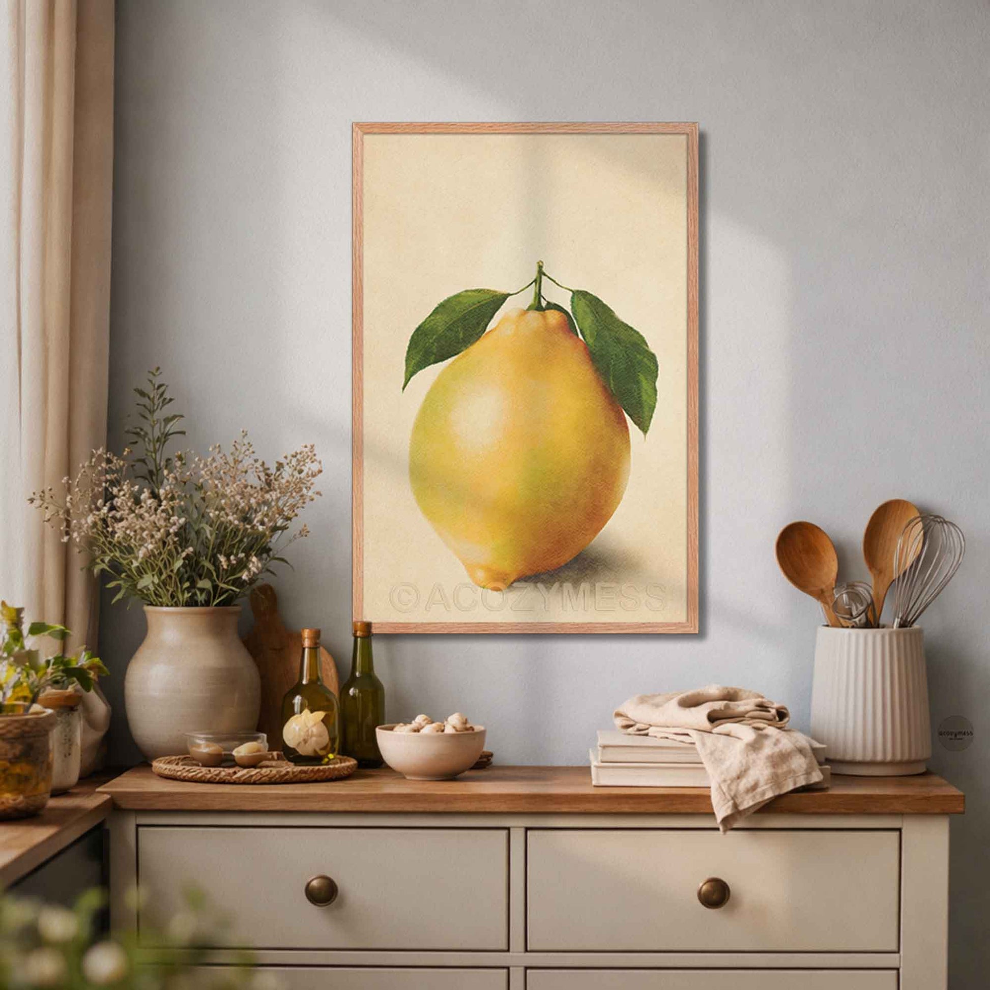 Framed artwork of a lemon on a kitchen counter with decorative items.