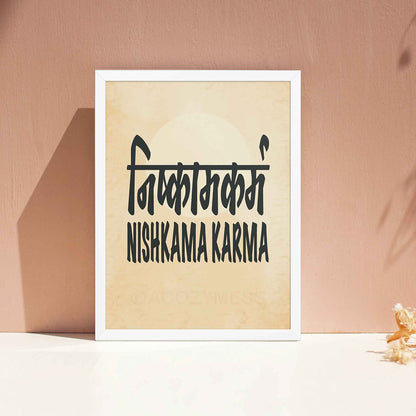 A white-framed typography poster featuring the concept of Nishkama Karma (निष्काम कर्म) in both Hindi and English on an aged, old-paper background.