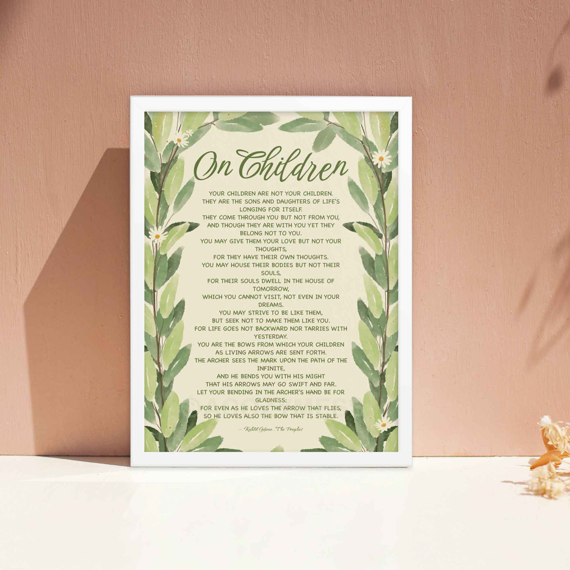 Poster featuring Kahlil Gibran’s quote, ‘Your children are not your children. They are the sons and daughters of Life’s longing for itself...’ with a leaves illustration, displayed in white frame.