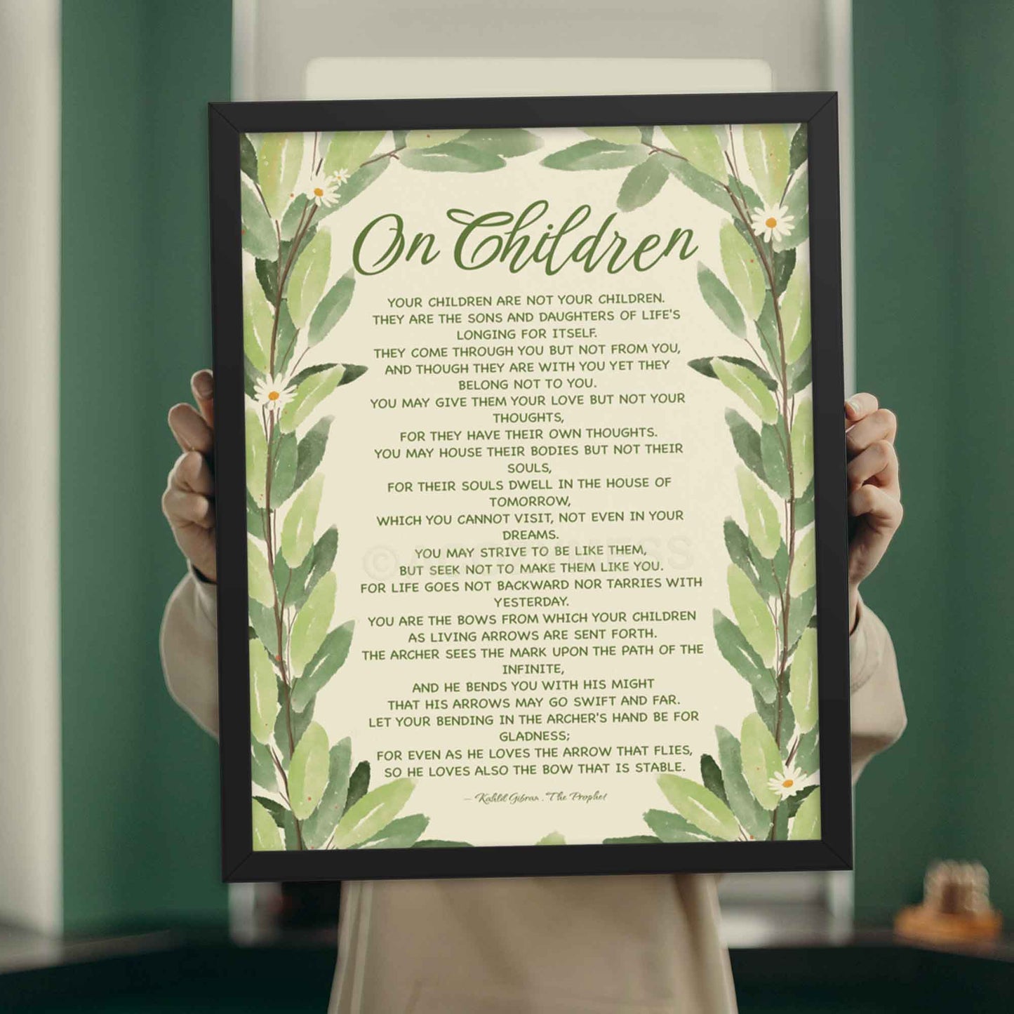 Poster featuring Kahlil Gibran’s quote, ‘Your children are not your children. They are the sons and daughters of Life’s longing for itself...’ with a leaves illustration, displayed in blacl frame.