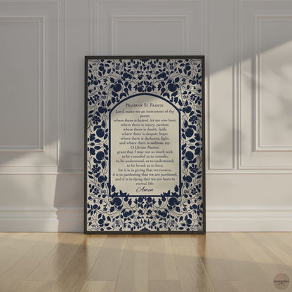 Video showcasing the Prayer of St. Francis poster in a black frame, highlighting the floral dark blue design on a  light beige background, with close-up shots and different angles for detail and room setting.