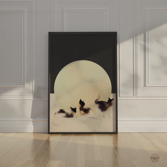 Contemporary cat wall art in black frame—three cats on dark gray and beige background for Scandinavian-style decor.