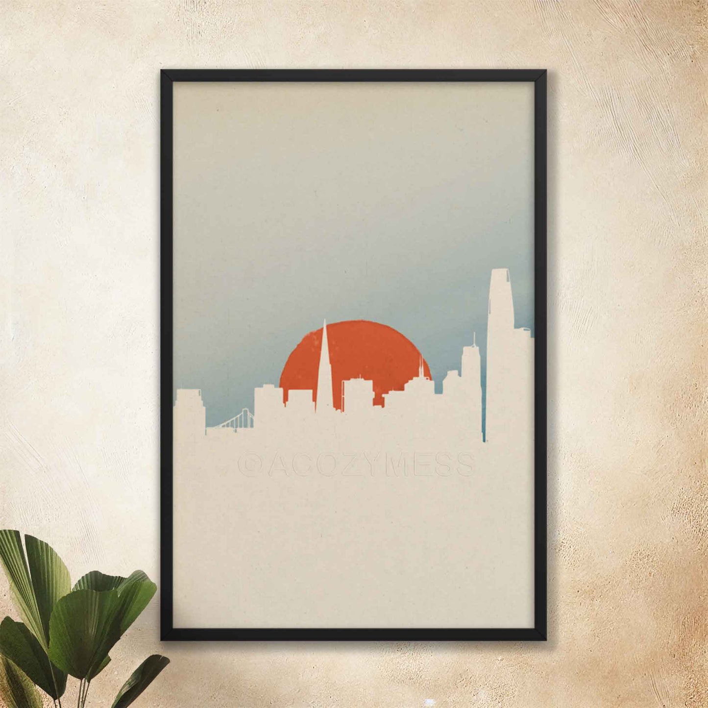 San Francisco skyline poster with minimal color palette and design in white, orange and blue, displayed in black frame.