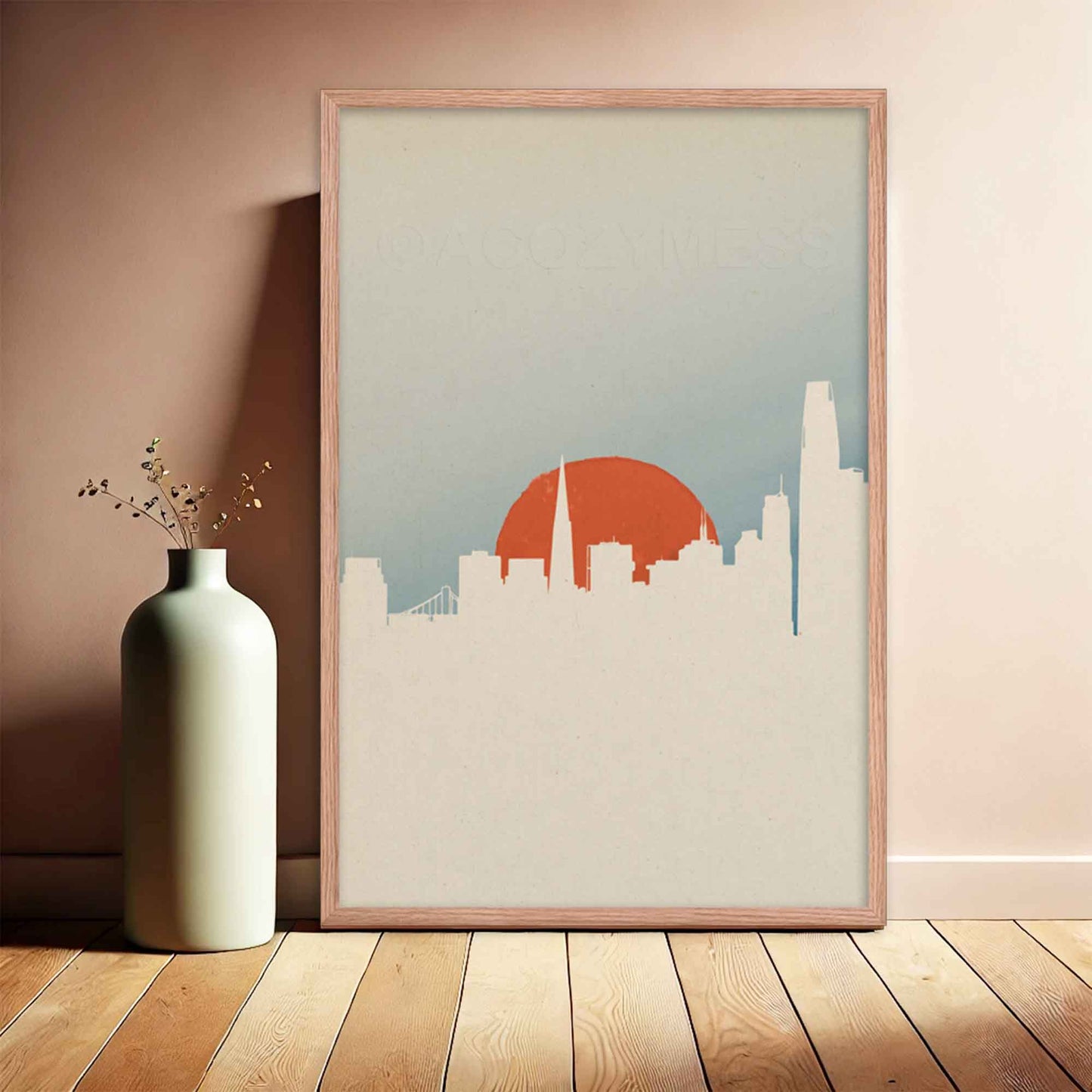 San Francisco skyline poster with minimal color palette and design in white, orange and blue, displayed in oakwood frame.