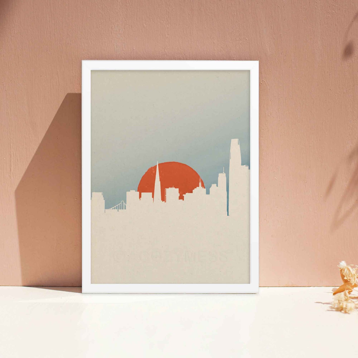 San Francisco skyline poster with minimal color palette and minimalist design in white, orange and blue, displayed in white frame.