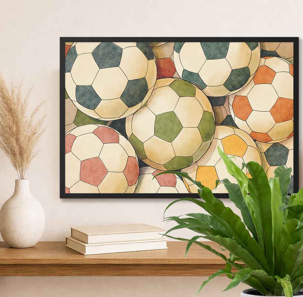 Horizontal Framed artwork of colorful soccer balls on a wall above a shelf with books and a plant.