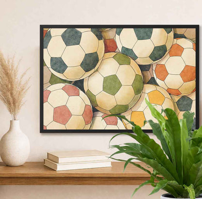 Horizontal Framed artwork of colorful soccer balls on a wall above a shelf with books and a plant.