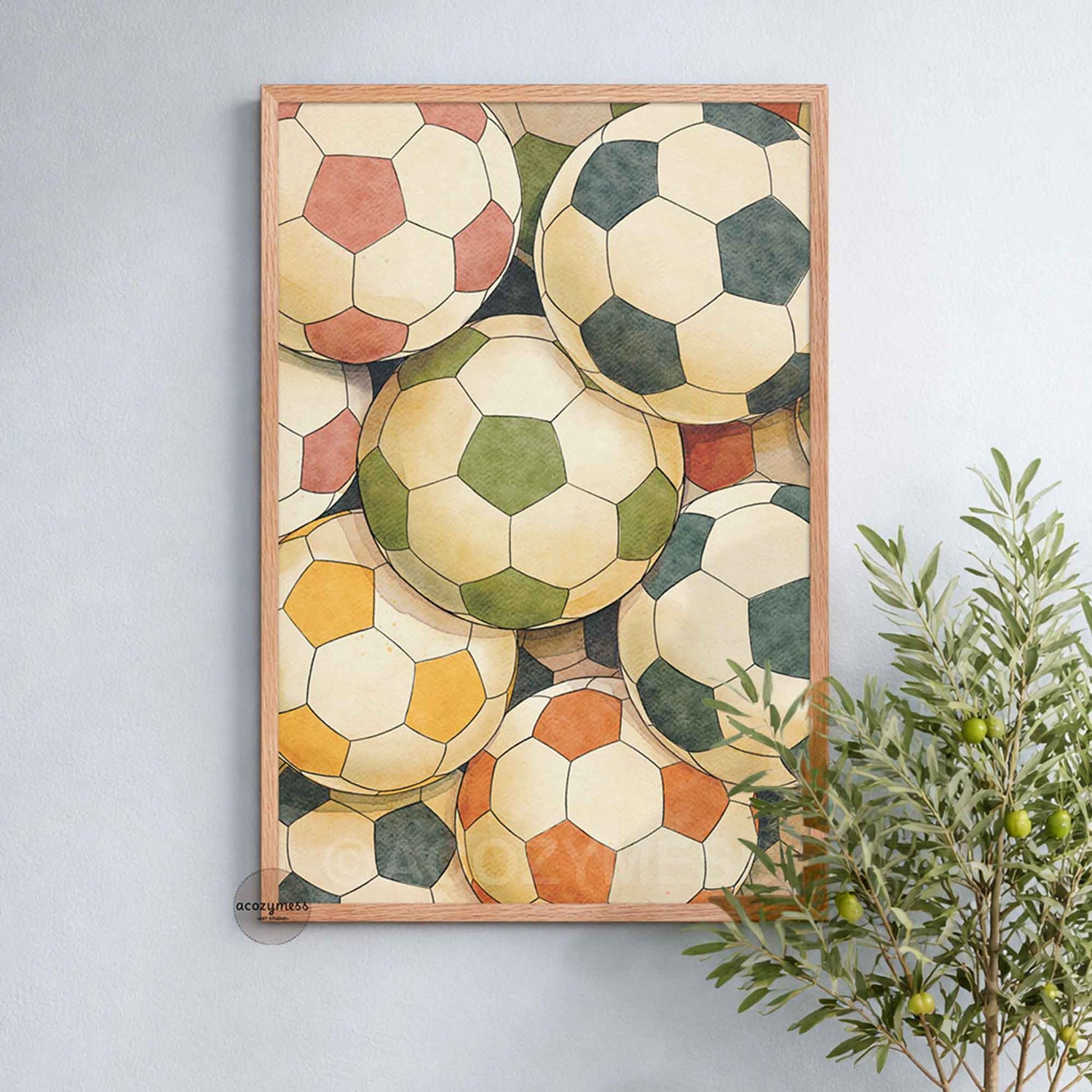 Framed artwork of vintage-style soccer balls on a light gray wall with a plant to the right.