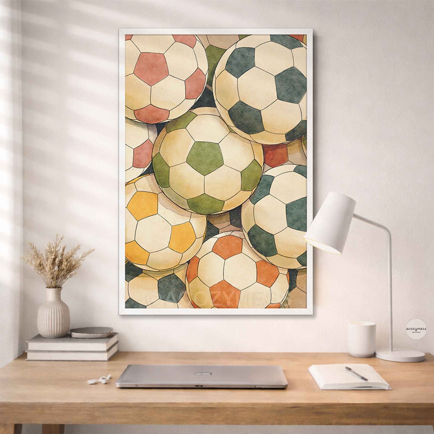 Framed artwork of vintage soccer balls on a wall above a desk.