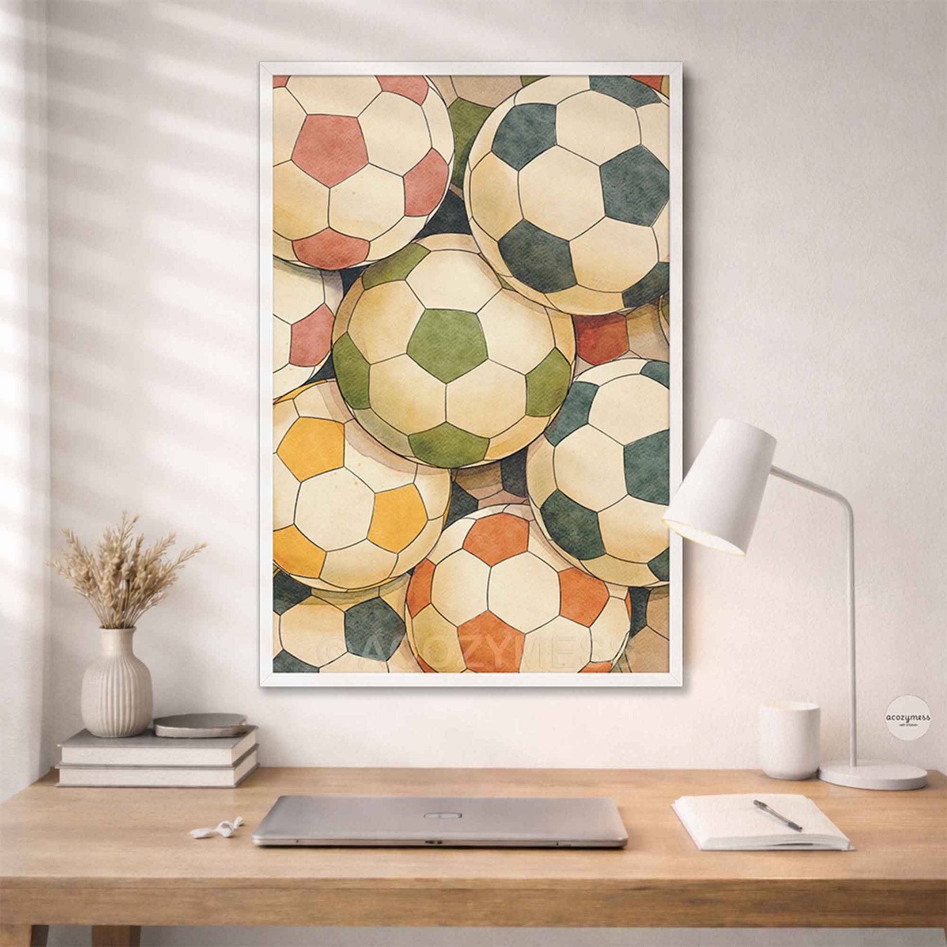 Framed artwork of vintage soccer balls on a wall above a desk.