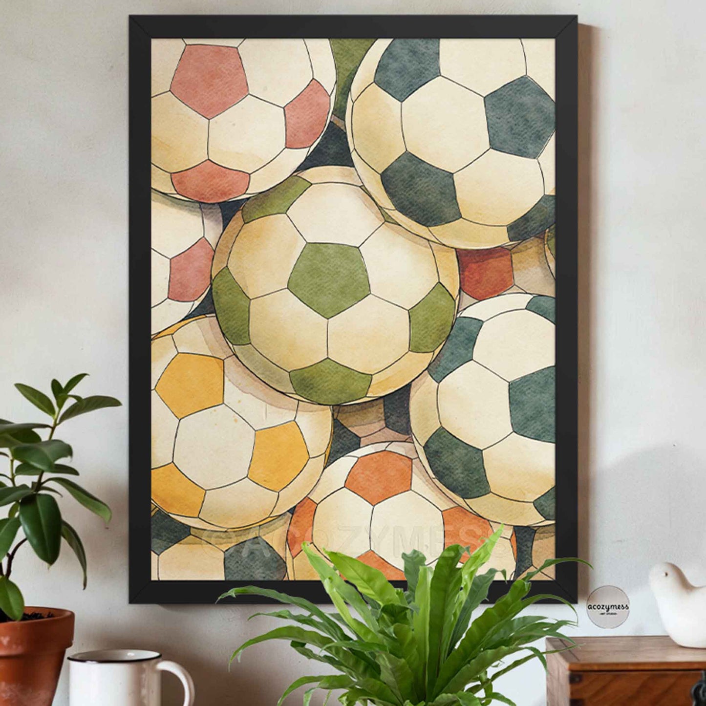 Framed artwork of stylized soccer balls on a wall.
