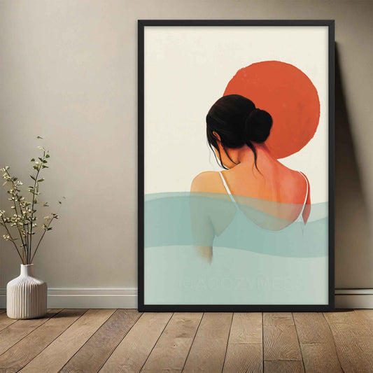 Calming wall art of sun and water featuring a woman in orange, white, pink and blue colors, displayed in black frame