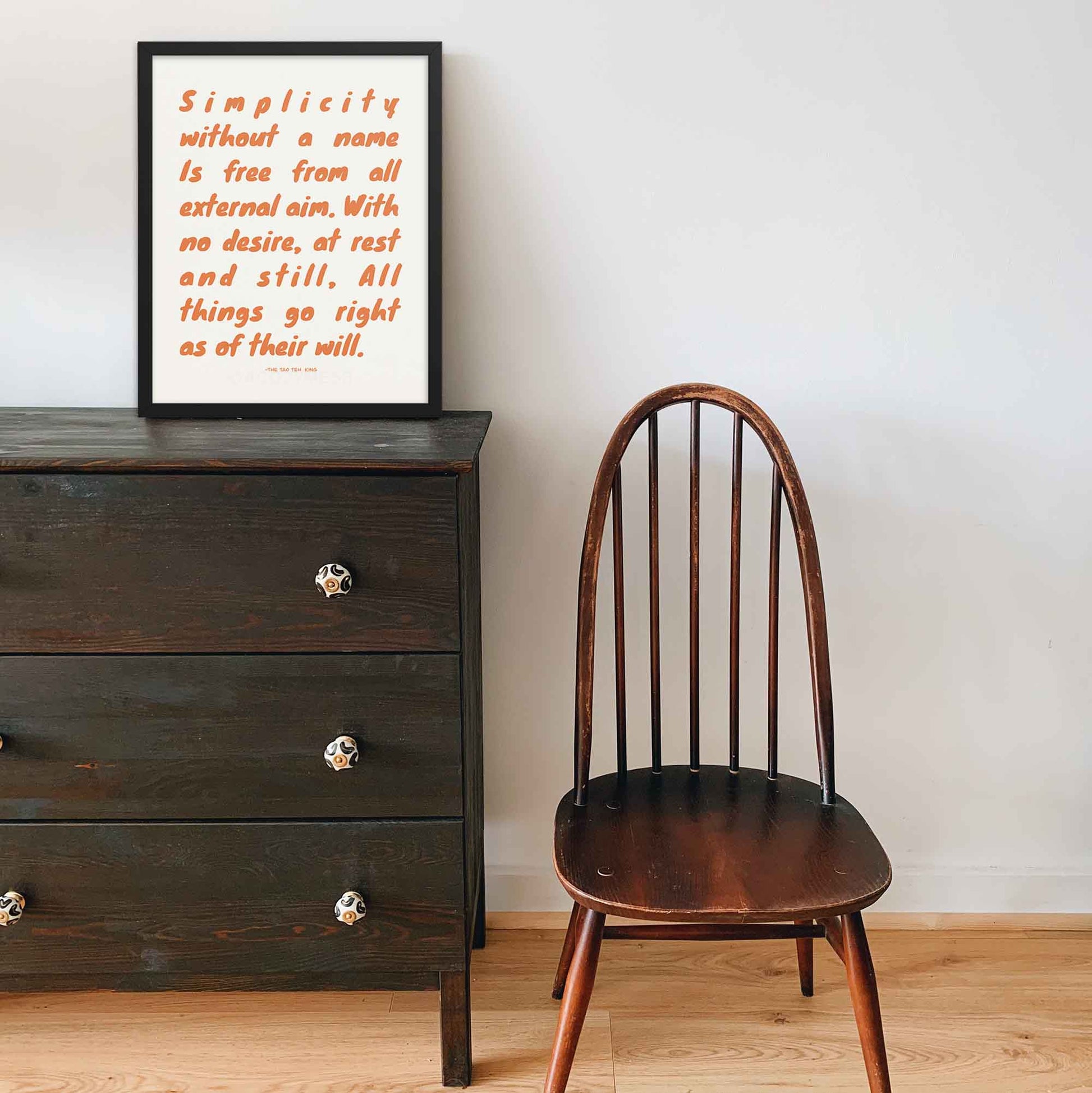 Typography print featuring tao teh king quote displayed in black frame