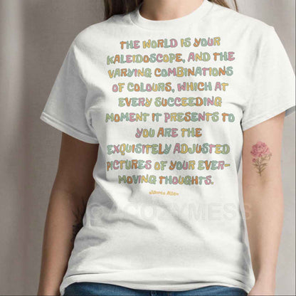 A woman wearing white T-shirt featuring an inspiring quote by James Allen: The world is your kaleidoscope, and the varying combinations of colors, which at every succeeding moment it presents to you are the exquisitely adjusted pictures of your ever-moving thoughts.