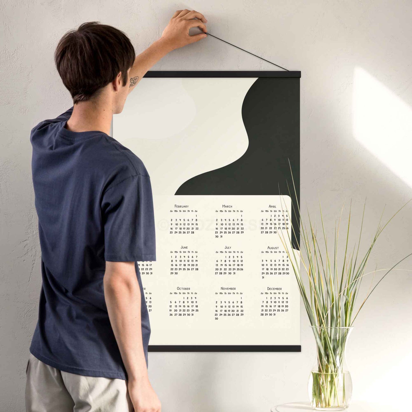 2025 yearly calendar poster with minimalist design, in black hanger, perfect for modern home or office decor.