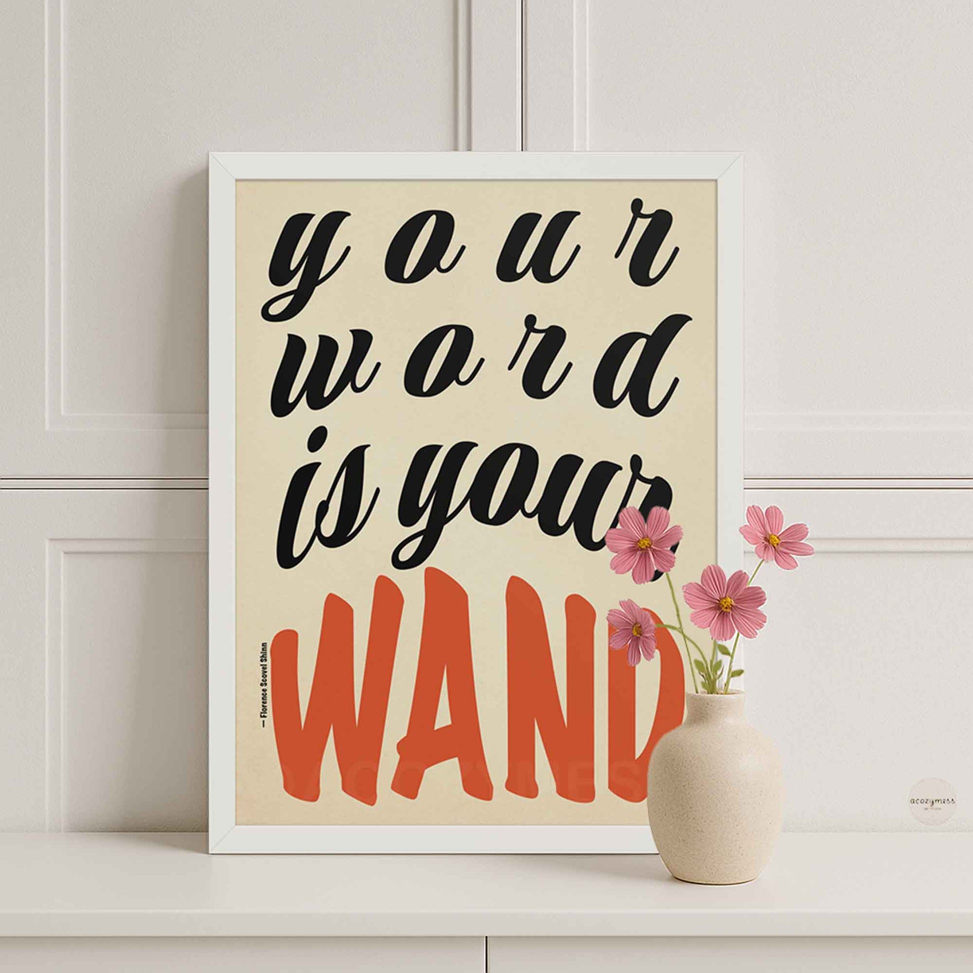 Beige background poster with “Your Word Is Your Wand” quote in black and red lettering, displayed in a sleek white frame against a soft, calming backdrop.