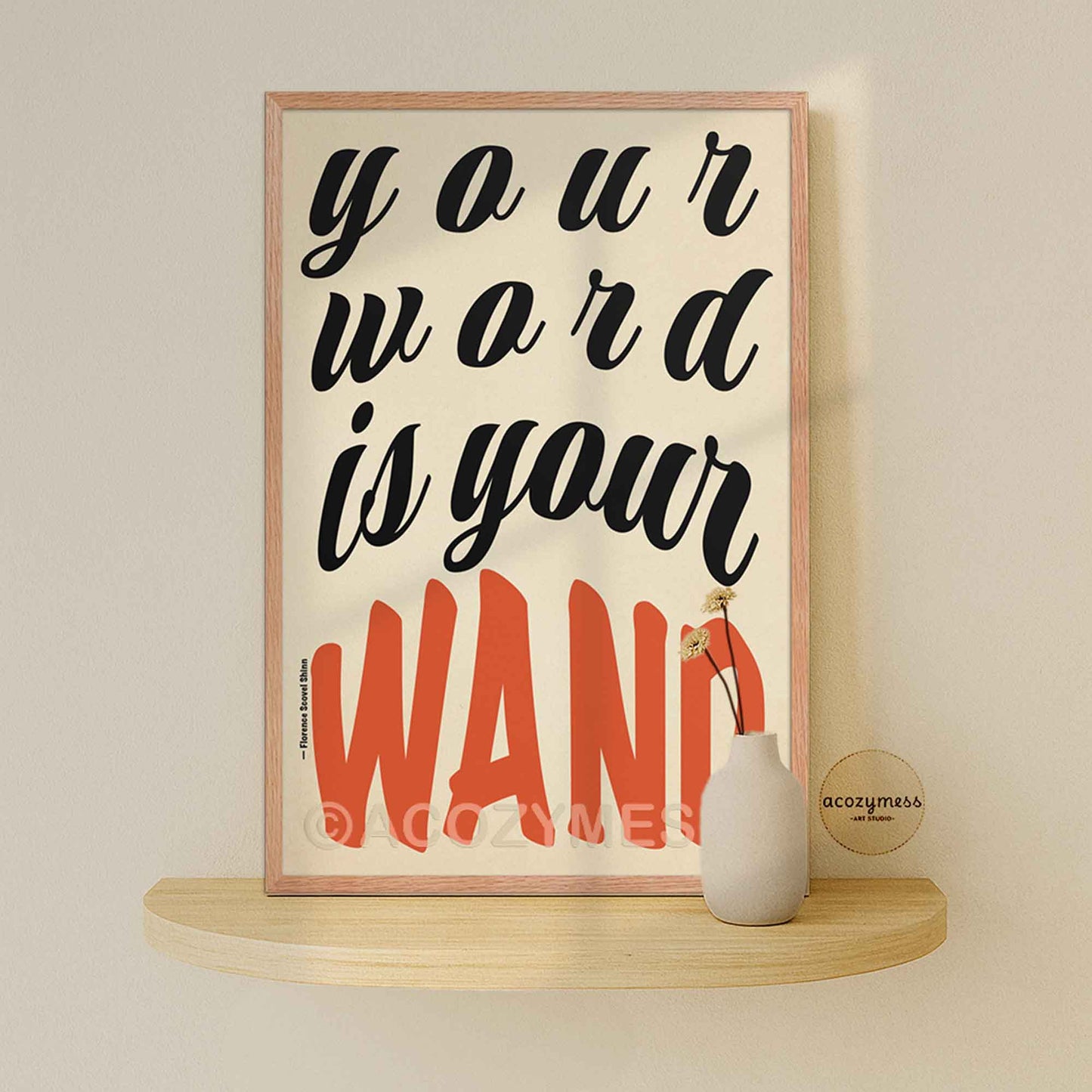 Framed poster with motivational quote on a shelf against a beige wall