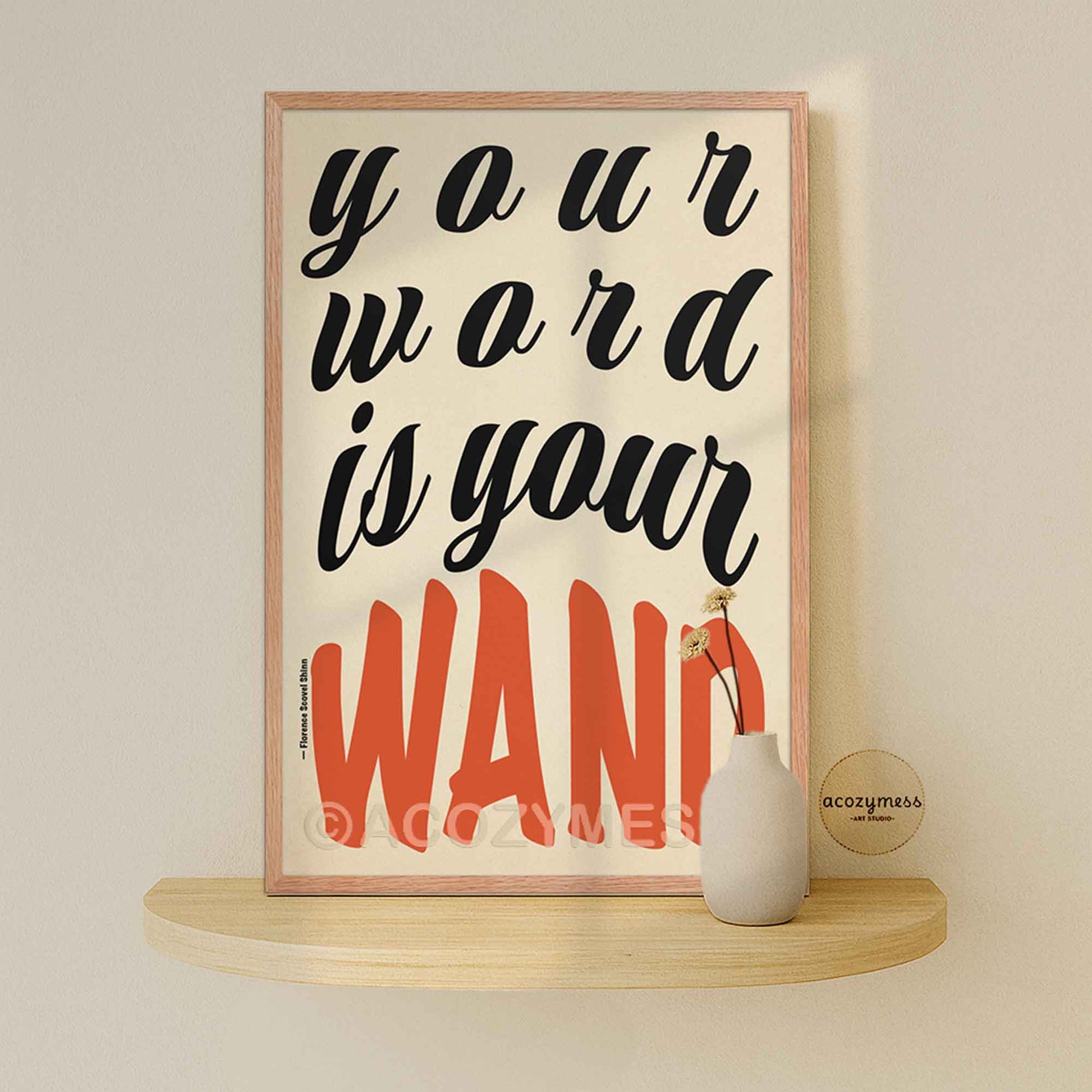Framed poster with motivational quote on a shelf against a beige wall