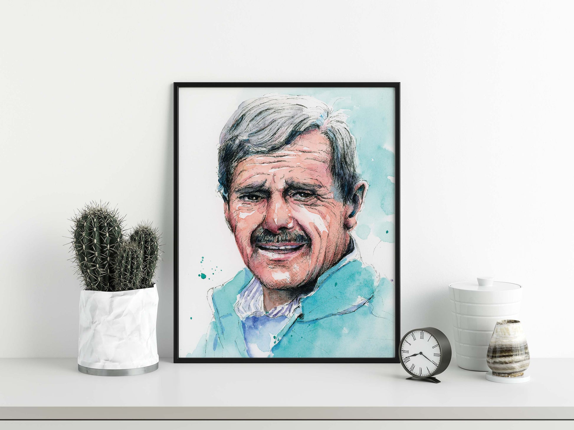 A smiling face portrait poster of a man wearing blue in watercolor in black frame