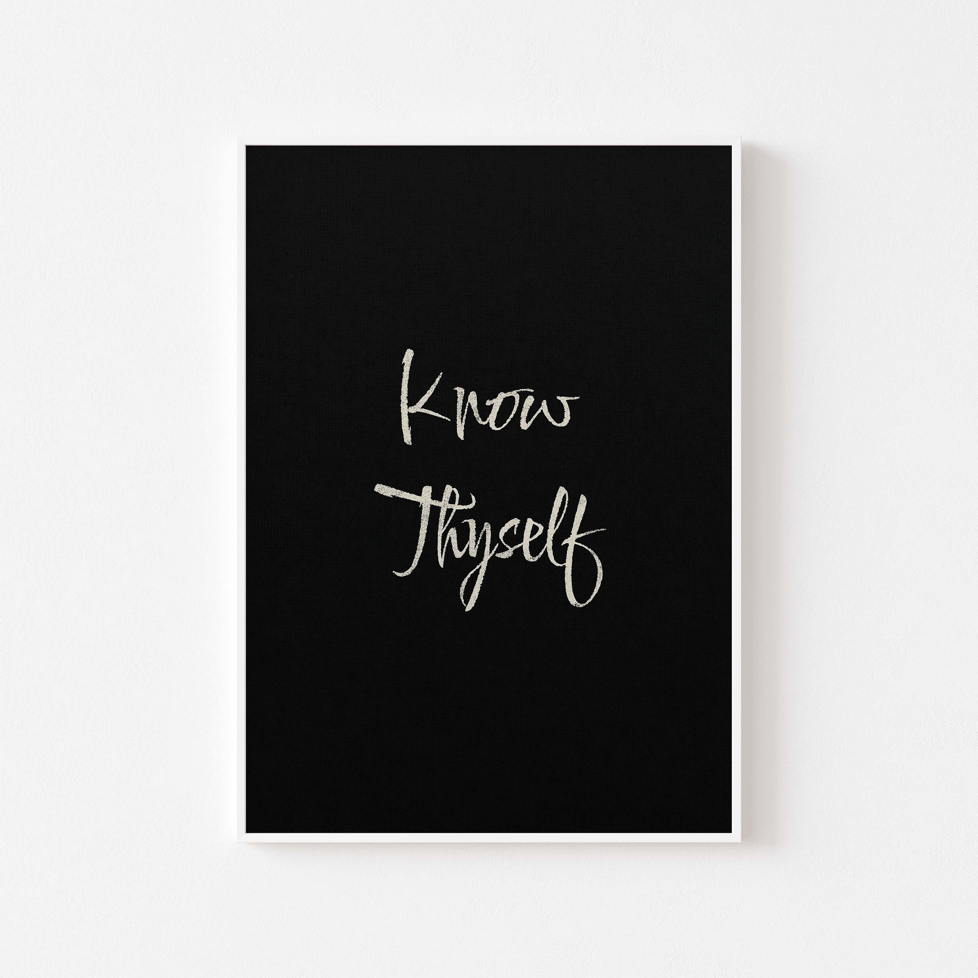 know thyself written in beige on black poster displayed in white frame