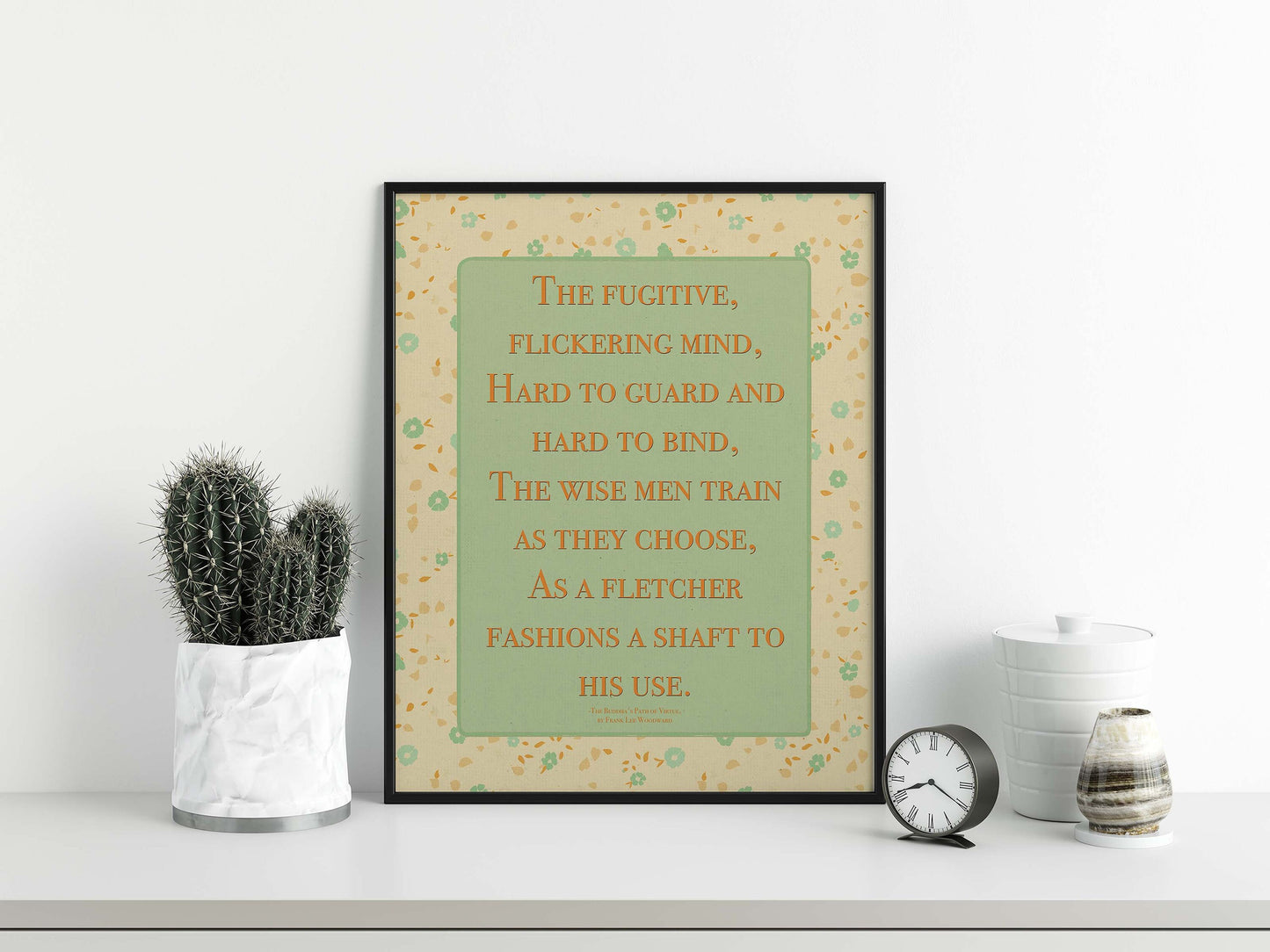 Dhammapada quote on mind poster in pastel colors with floral design in black frame display