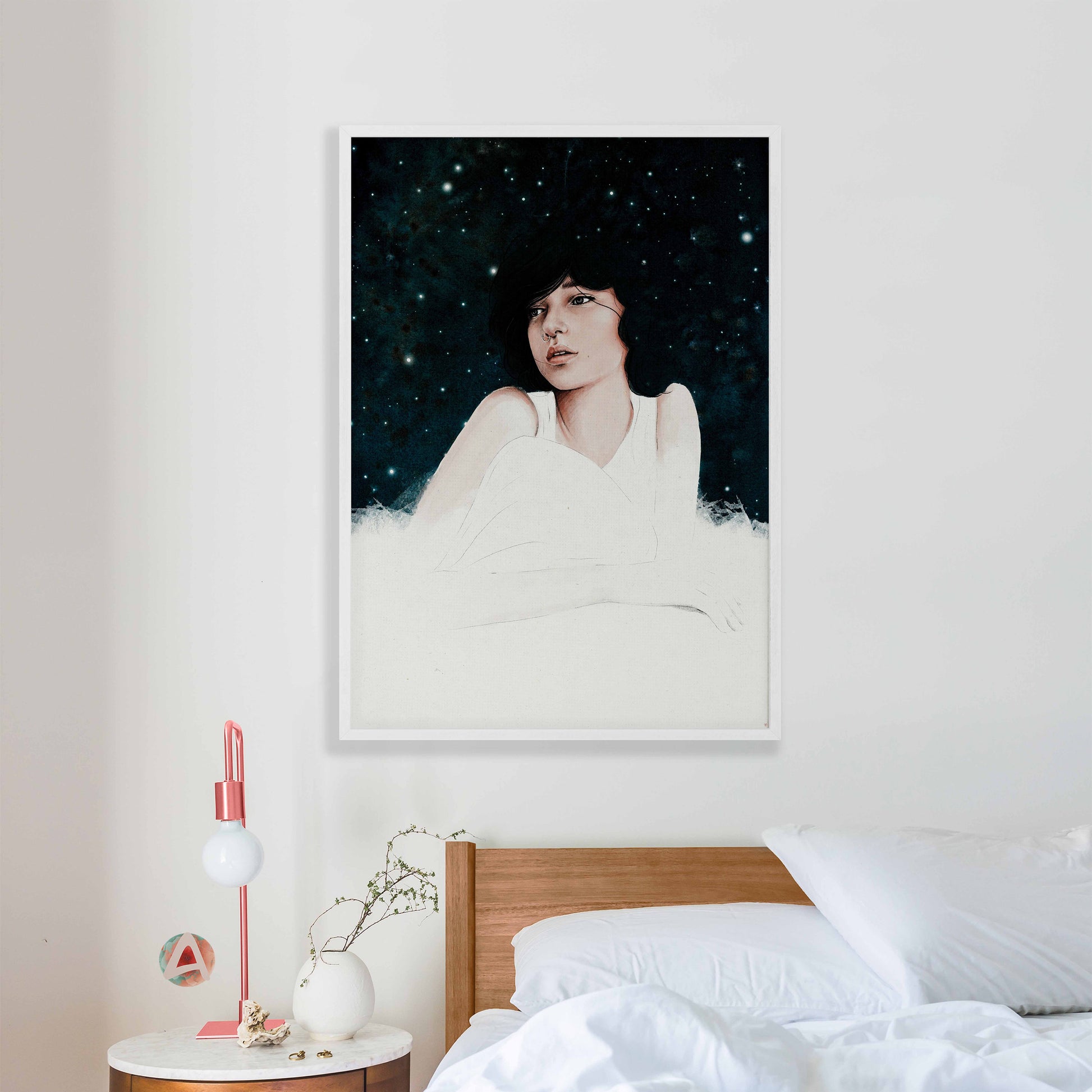 Dreamy girl art print in dark blue, pink & white in white frame mockup in bedroom