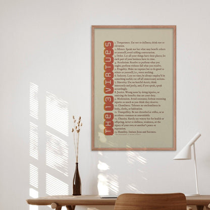 13 Virtues by Benjamin Franklin poster in red on beige, in a oakwood frame displayed in a study or office decor.