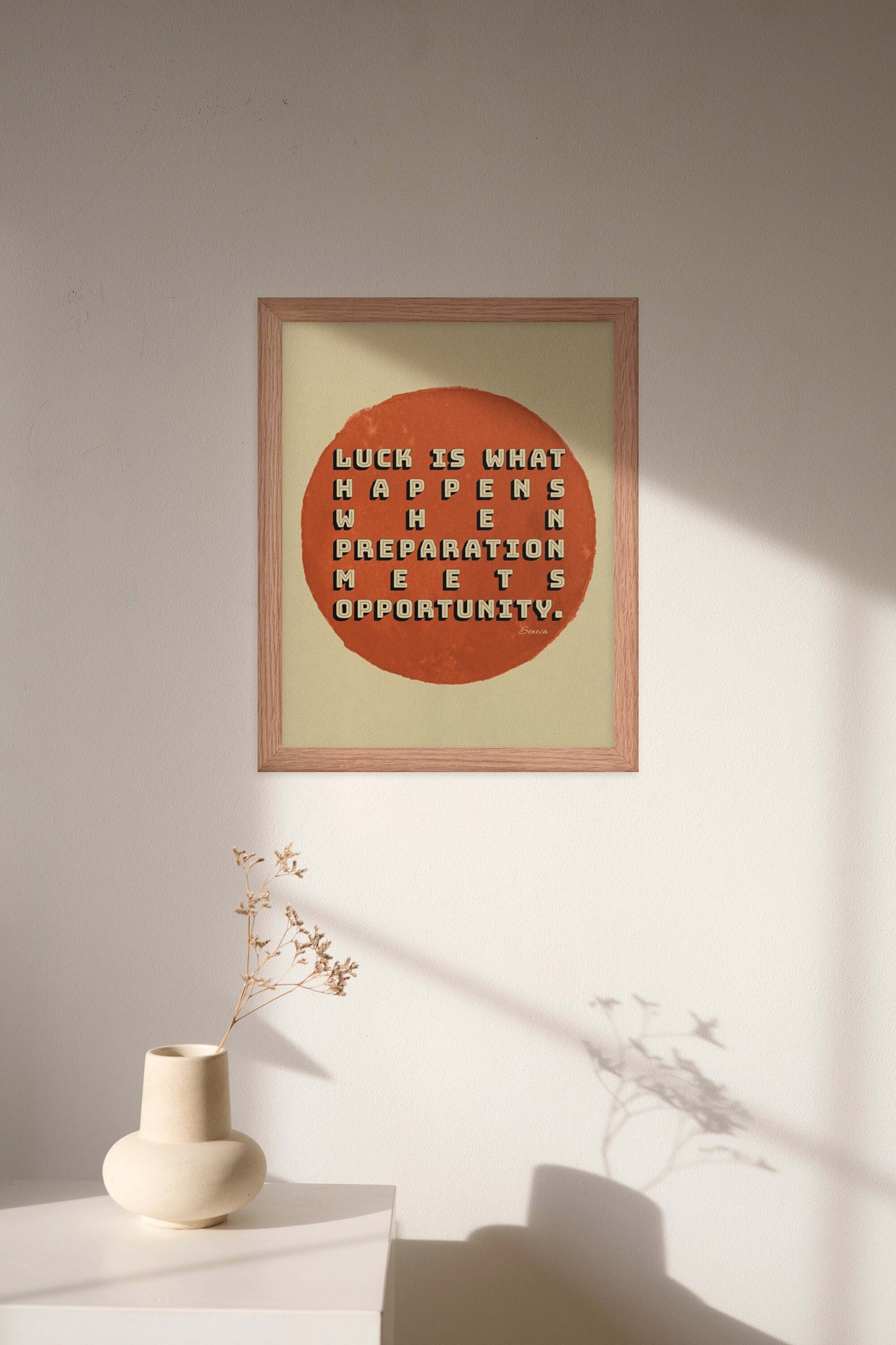 Seneca quote on luck in beige & red poster in oak frame.