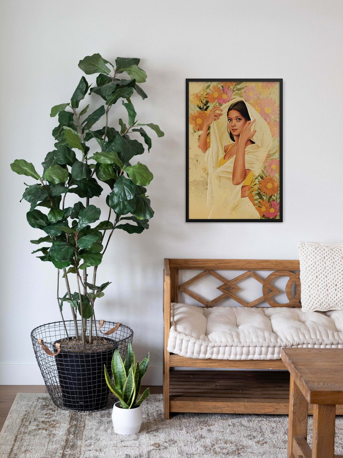 Woman in beige polka dots saree with yellow blouse in pink, orange, yellow  floral background black framed wall art on living room wall.